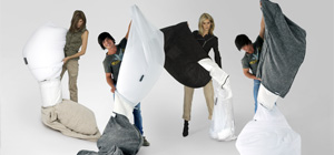 Group of people filling their bean bags with a new zip and tip filling system