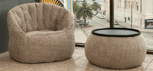 Brown creamy nude bean bag sofa chair with brown wing ottoman table overlooking Luna Park