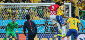 Brazil Soccer Players in yellow jersey tries to kick goal while Croatia in red jersey tries to block of the score in World Cup 2014