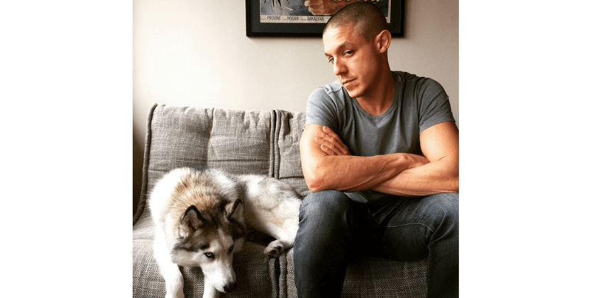 American actor Theo Rossi and his Siberian husky sitting on Ambient Lounge grey Twin Couch bean bag sofa chair