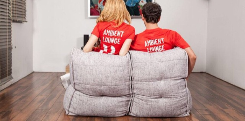 man and a woman watching a game on an Ambient lounge twin sofa