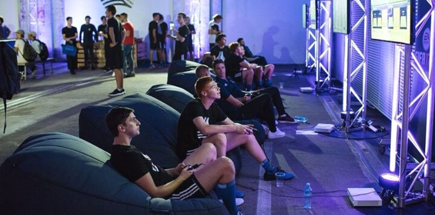 gents playing games on an Ambient lounge Satellin twin sofa