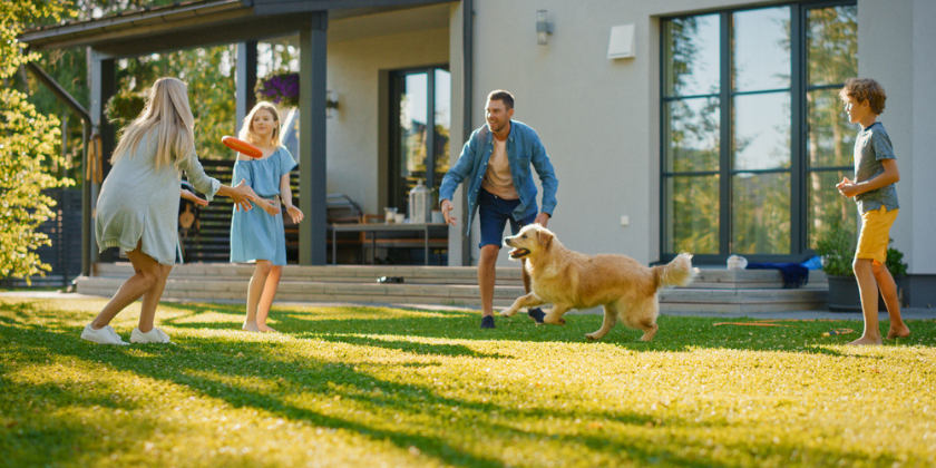 FAMILY PLAYING WITH THEIR DOG