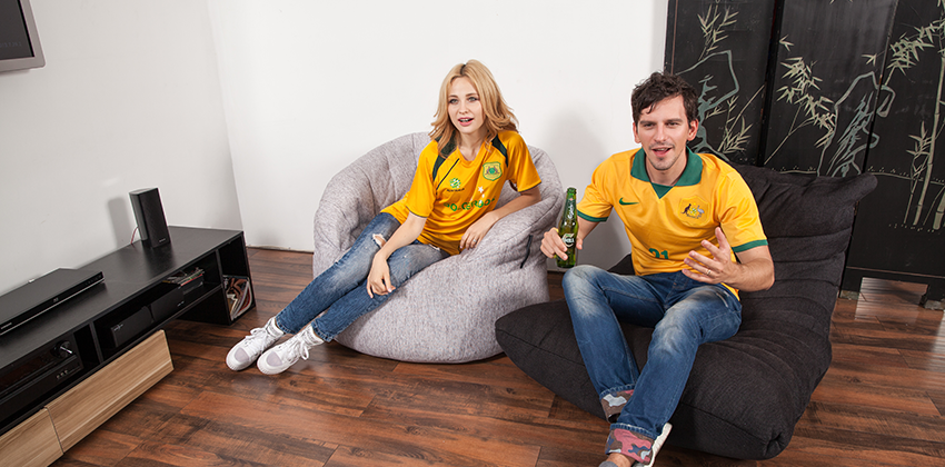 Couple watches world cup game 1 in television in absolute comfort in Butterfly bean bag Sofa